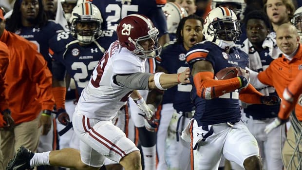 Alabama wide receiver Caleb Sims (29) grabs for Auburn cornerback Chris Davis (11) during the Iron Bowl at Jordan-Hare Stadium on Saturday, Nov. 30, 2013. Ironbowl2013no2